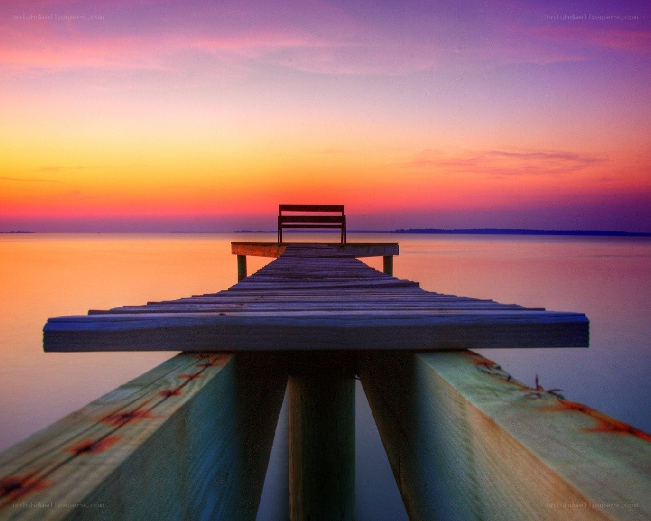 Pier at sunset with bench