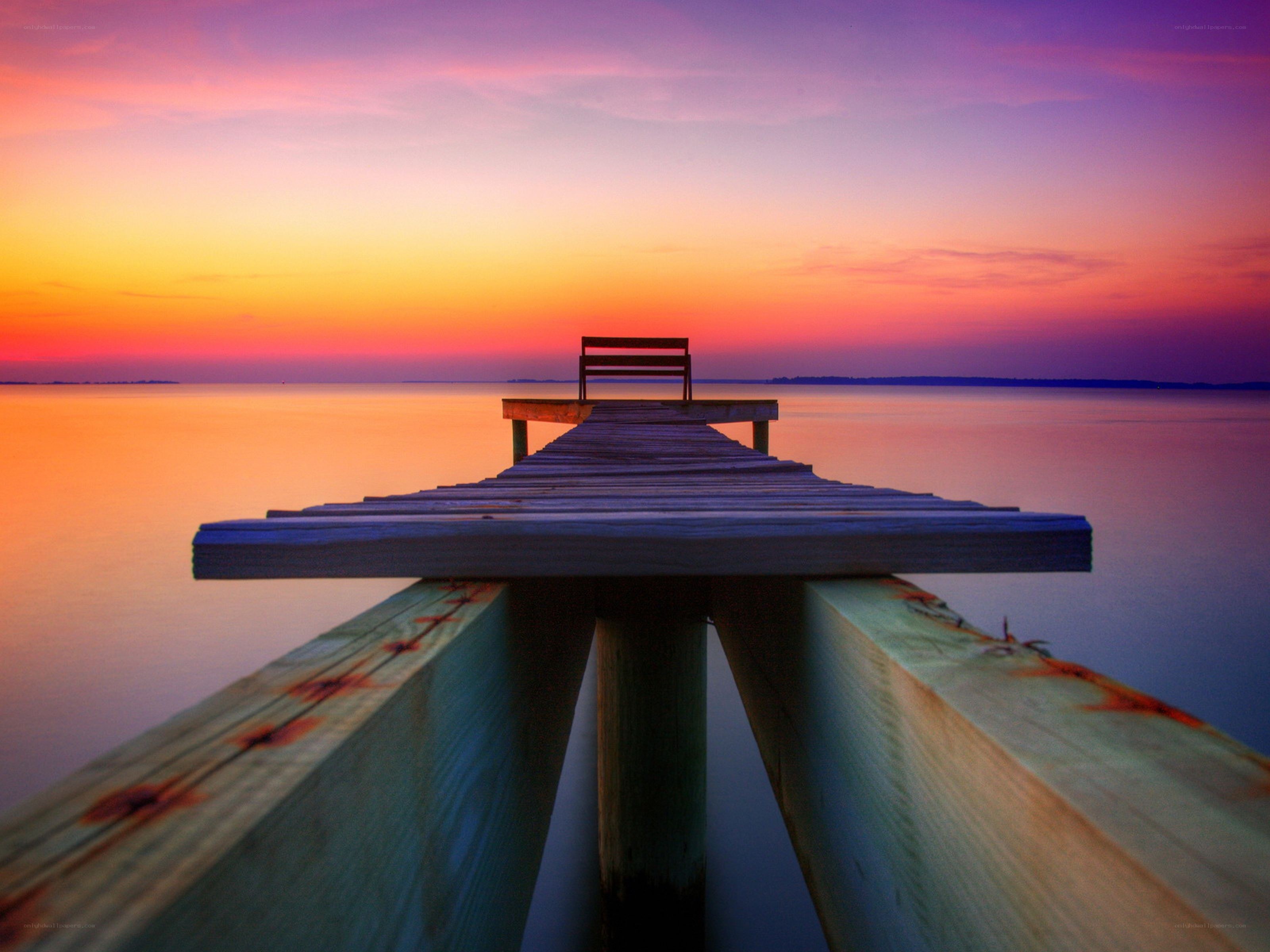 Pier at sunset with bench