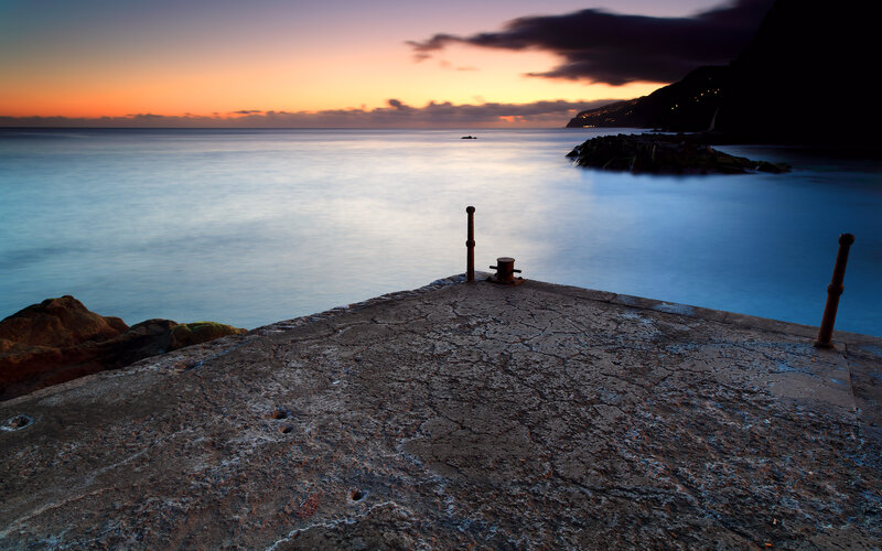 Pier at sunset with calm sea