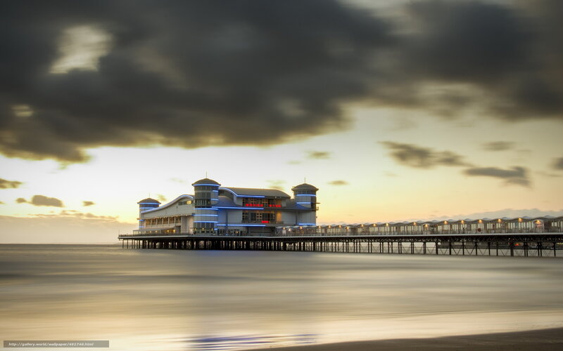 Pier at sunset with clouds
