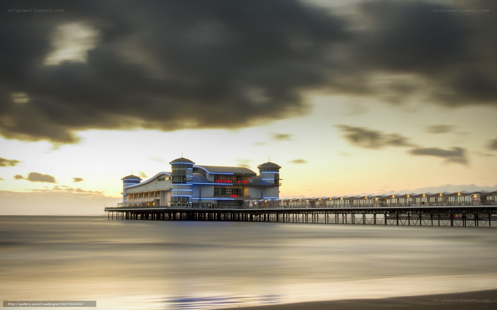 Pier at sunset with clouds