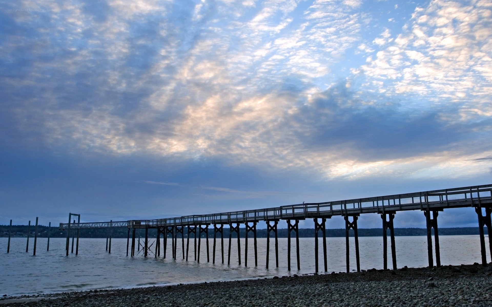 Pier at sunset with cloudy sky