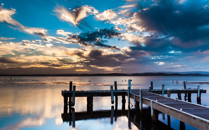 Pier at sunset with cloudy sky