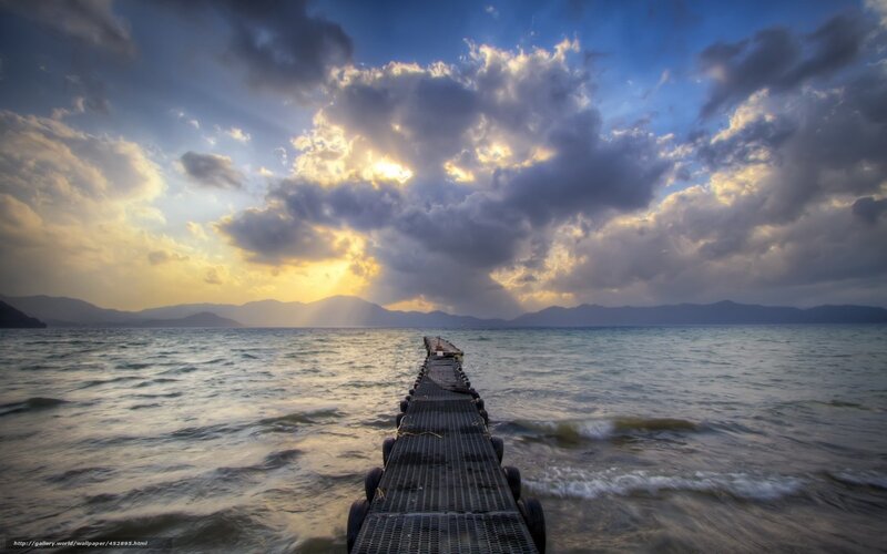Pier at sunset with dramatic clouds