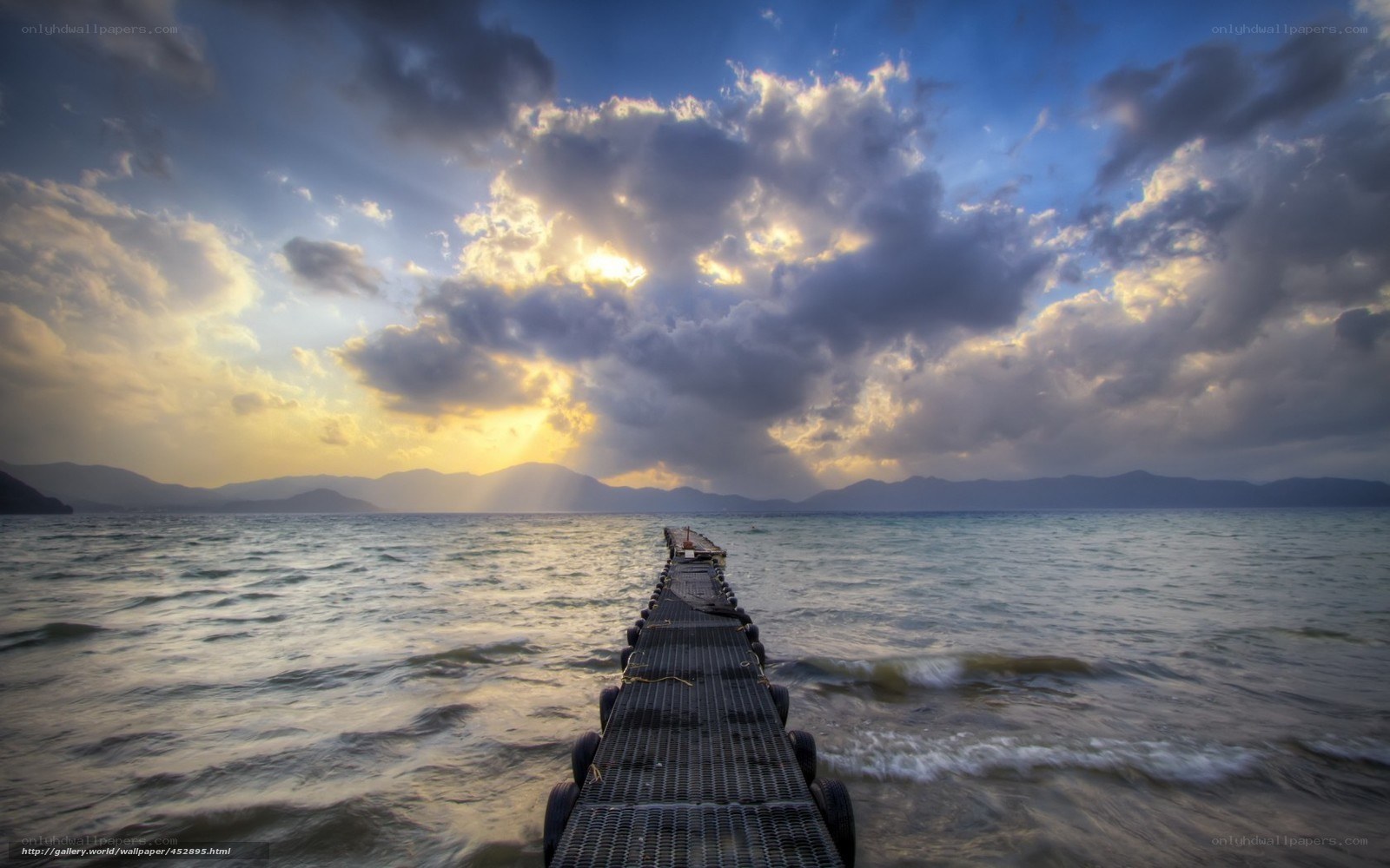 Pier at sunset with dramatic clouds
