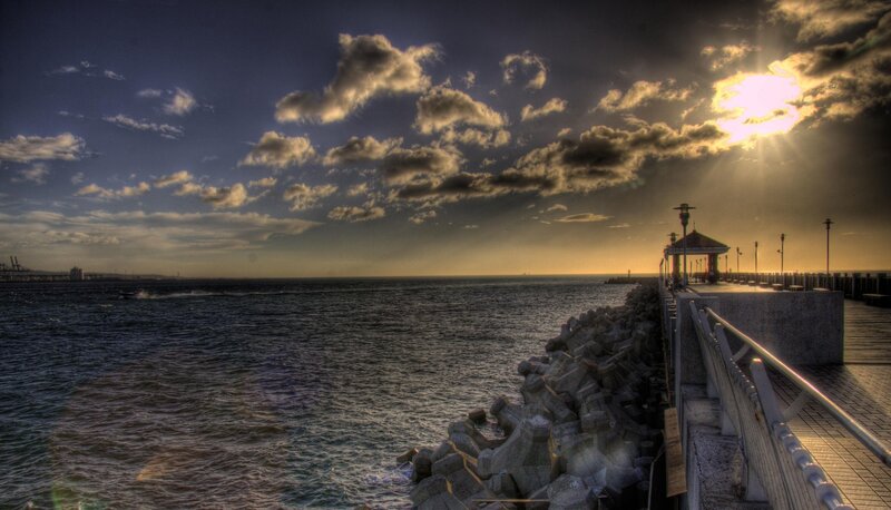 Pier at sunset with dramatic clouds