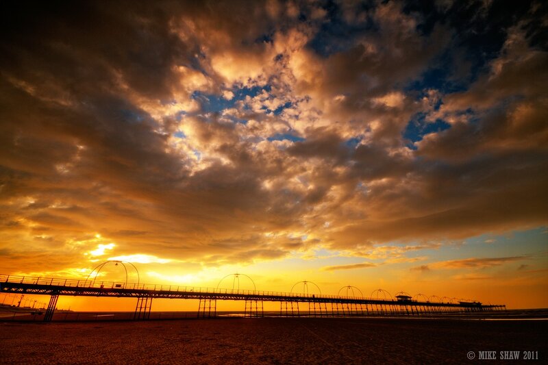 Pier at sunset with dramatic clouds