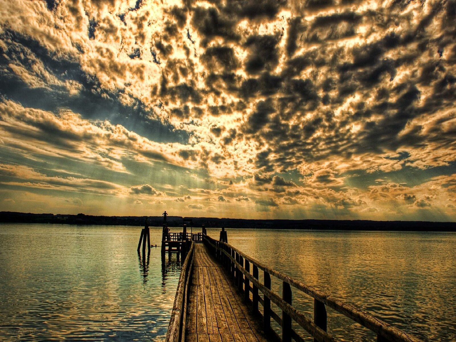 Pier at sunset with dramatic clouds