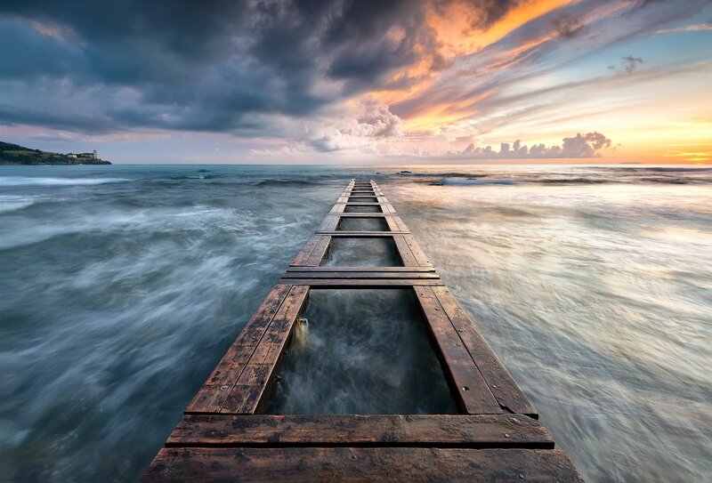 Pier at sunset with dramatic sky