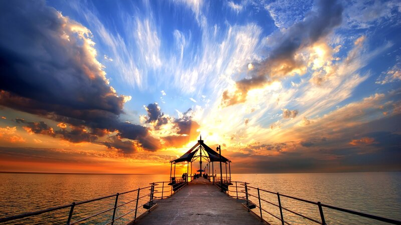 Pier at sunset with dramatic sky