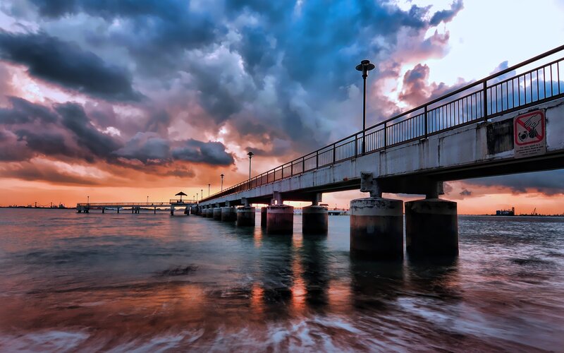 Pier at sunset with dramatic sky