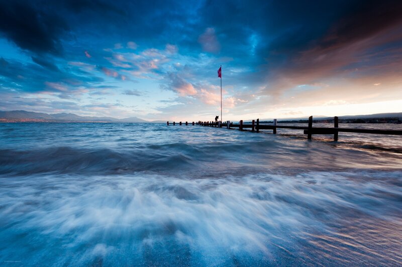 Pier at sunset with flag