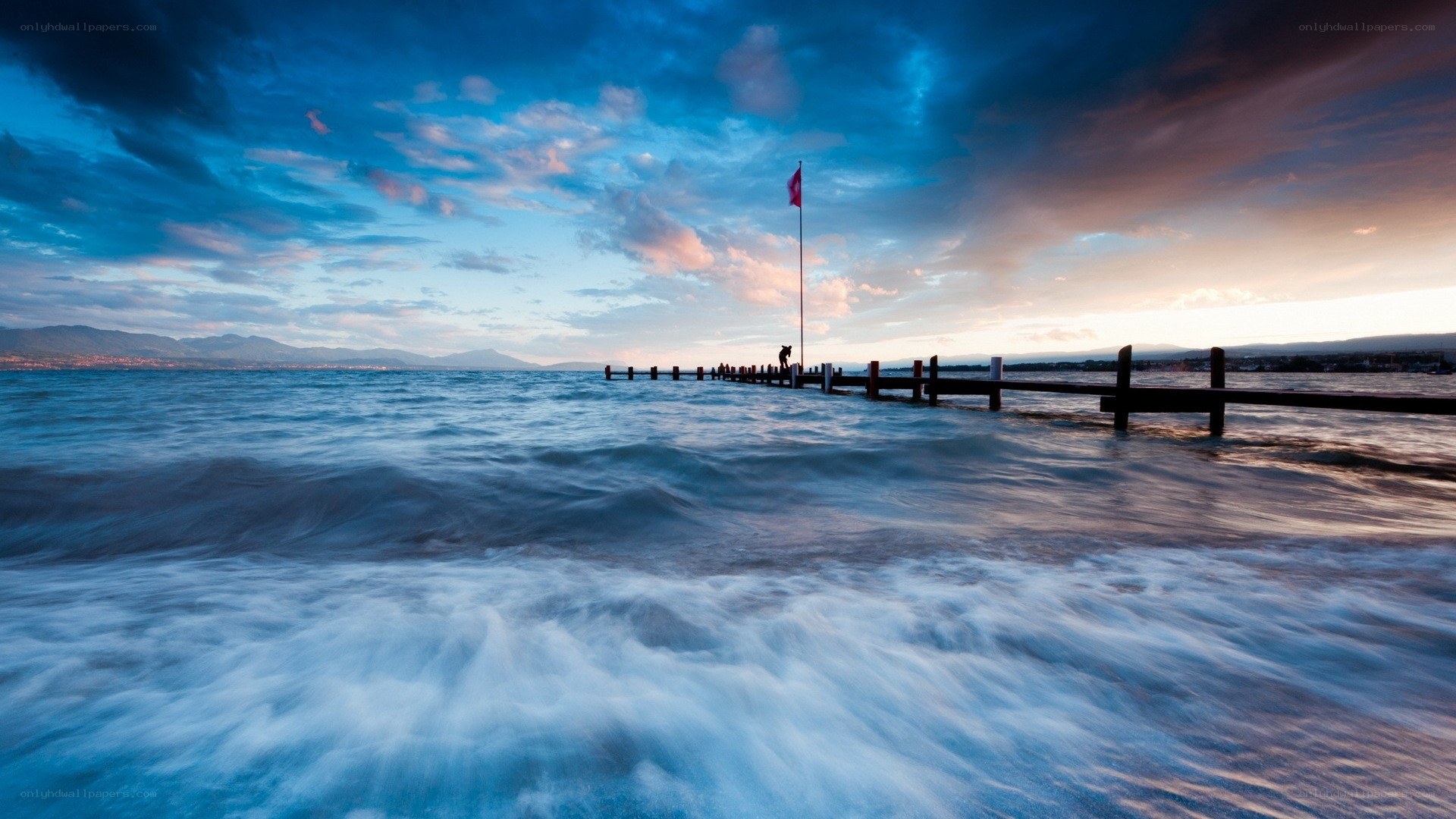 Pier at sunset with flag