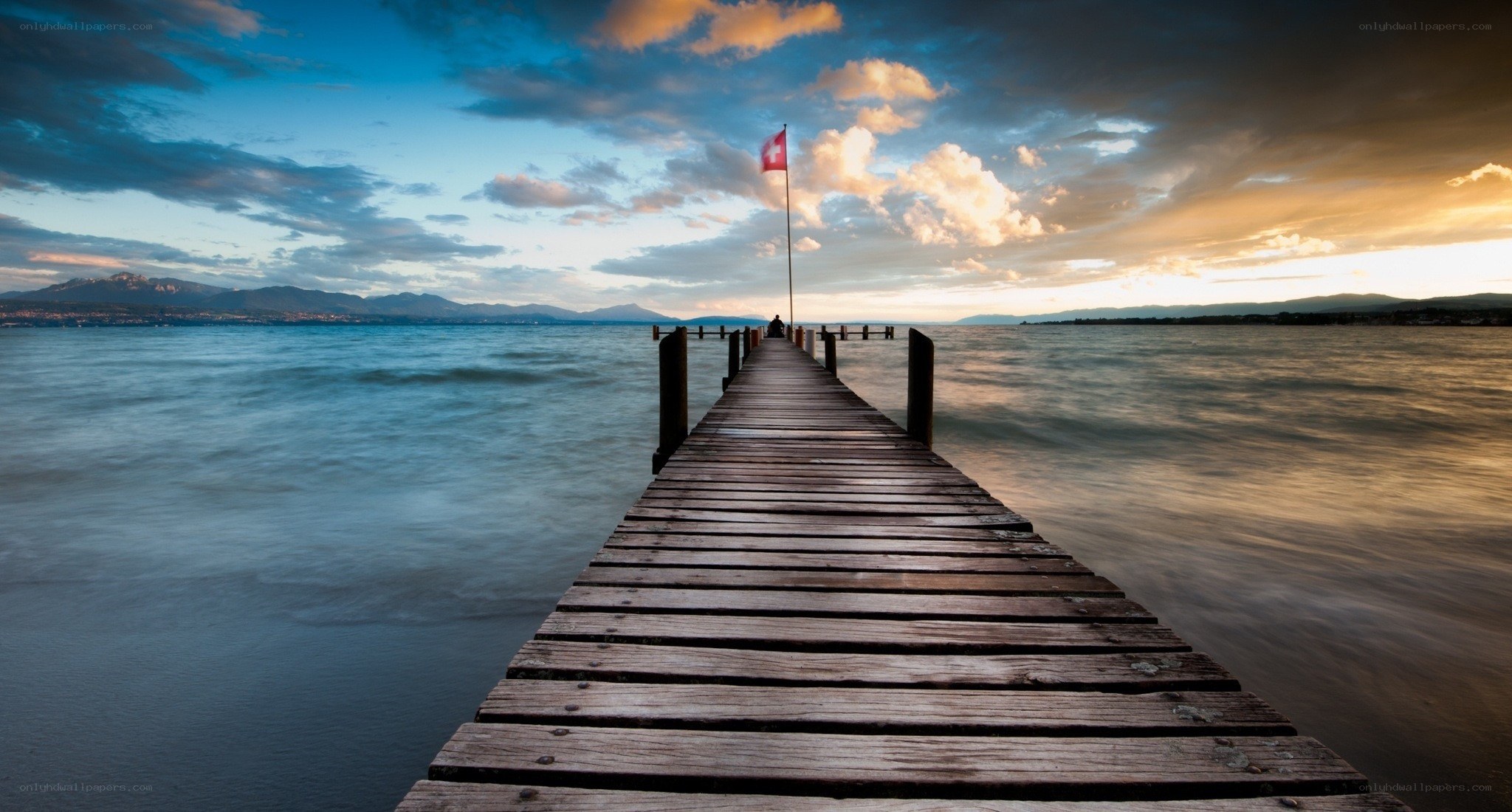 Pier at sunset with flag