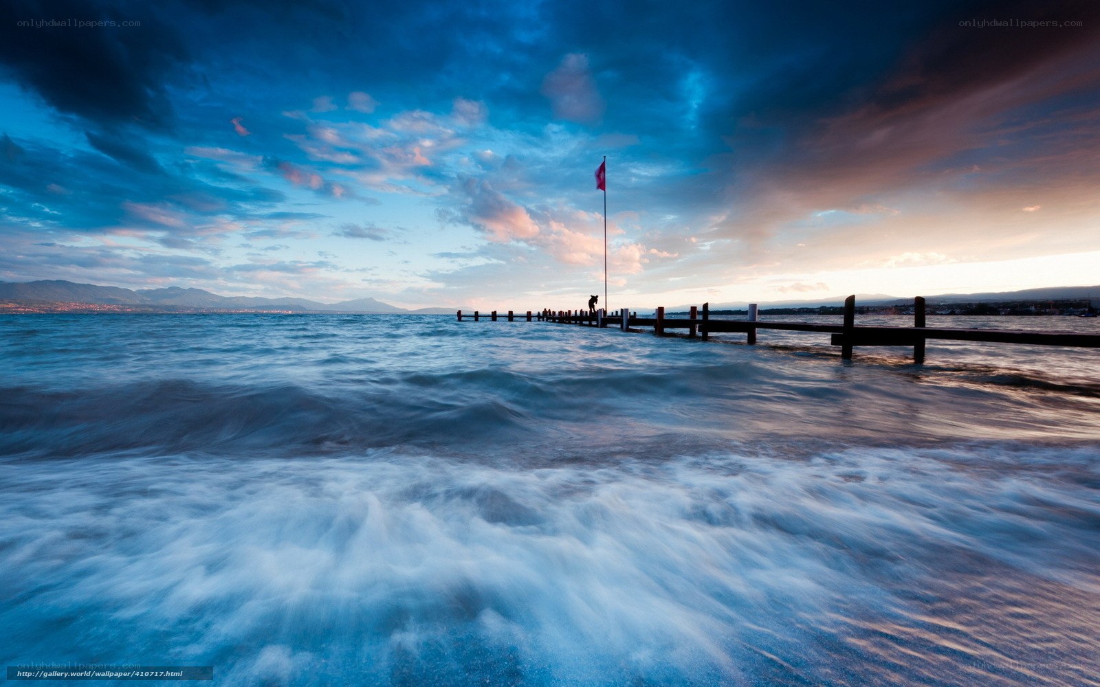 Pier at sunset with flag