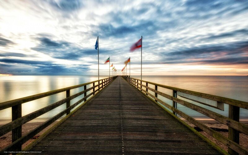 Pier at sunset with flags