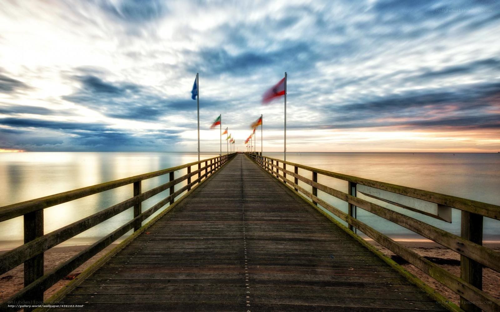 Pier at sunset with flags