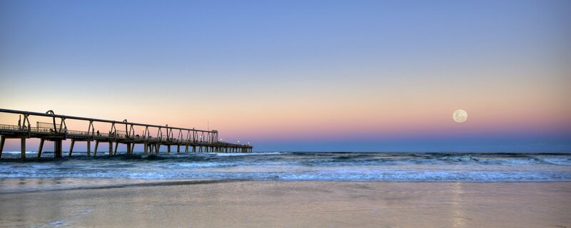 Pier at sunset with full moon
