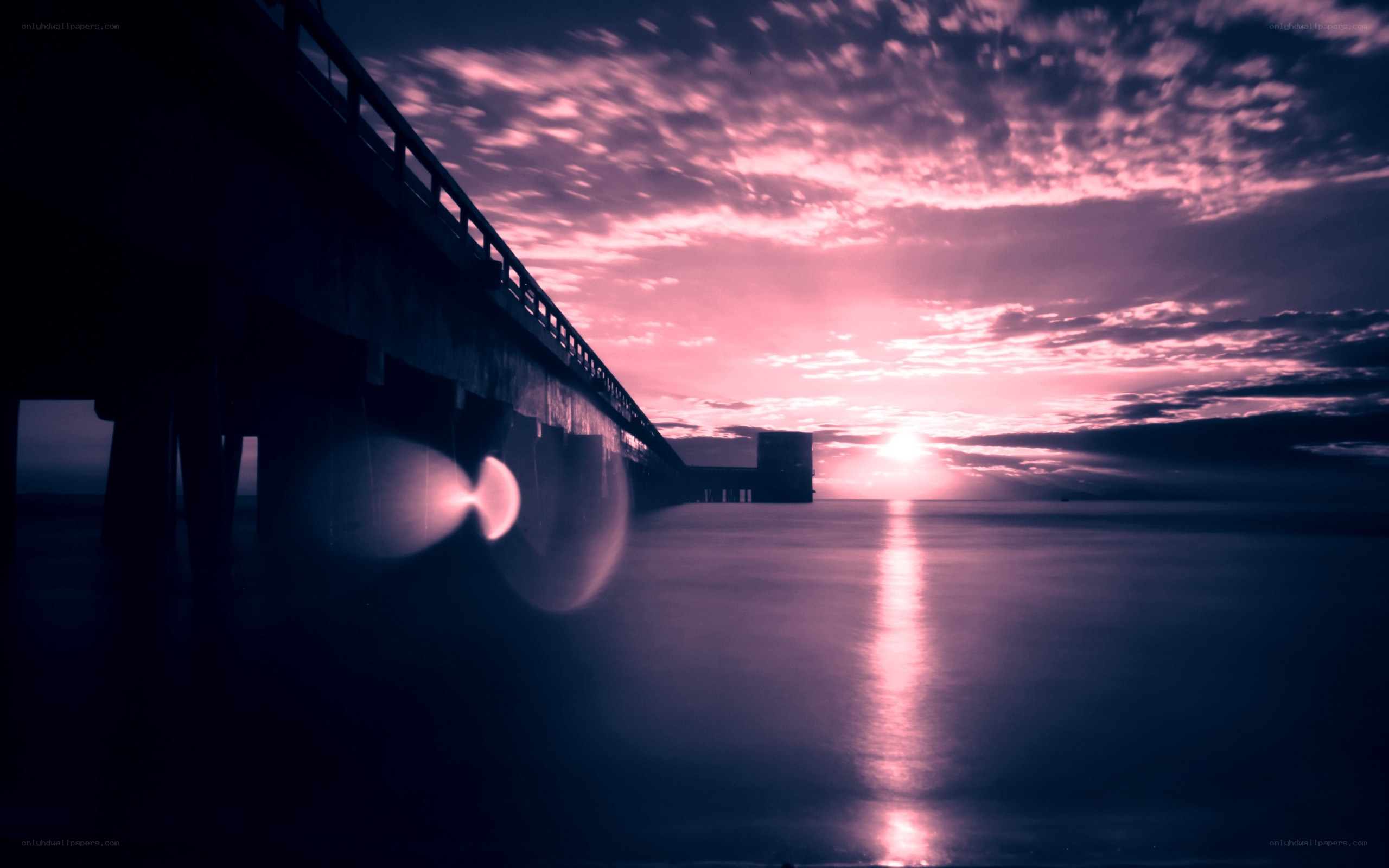 Pier at sunset with lens flare