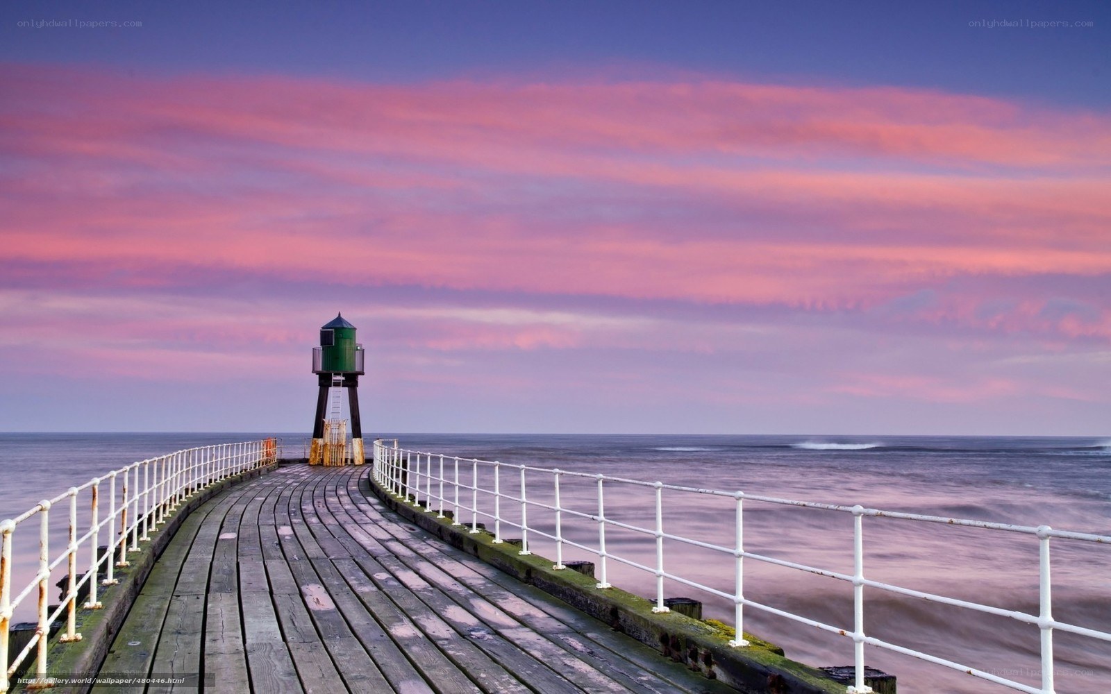 Pier at sunset with lighthouse