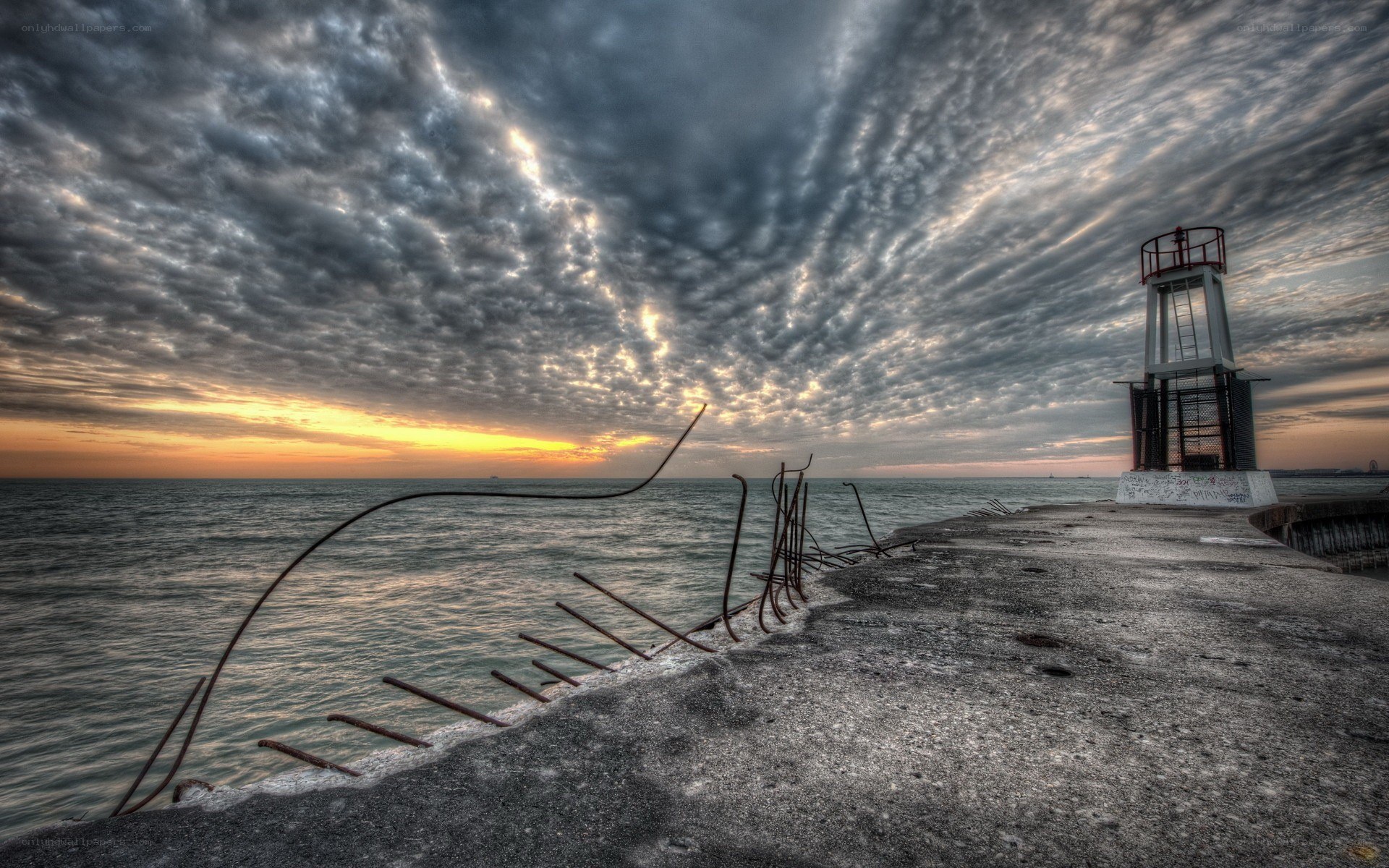 Pier at sunset with lighthouse