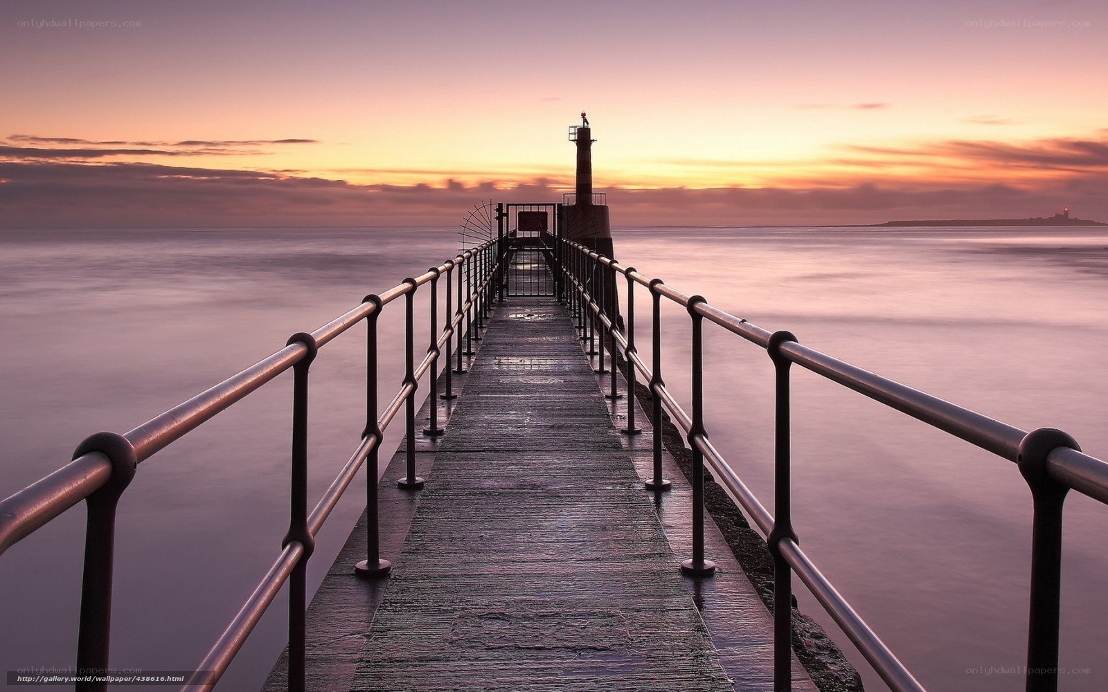 Pier at sunset with lighthouse