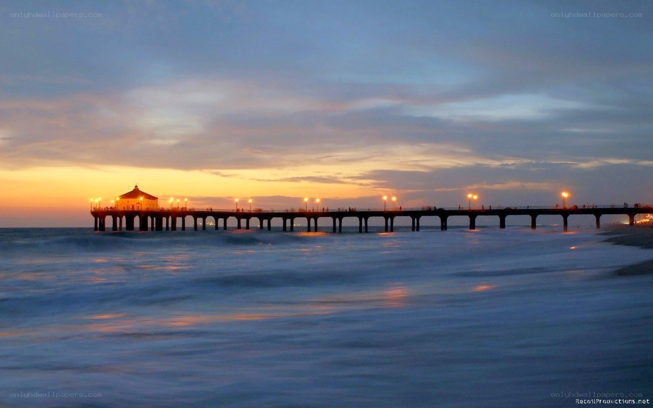 Pier at sunset with ocean waves