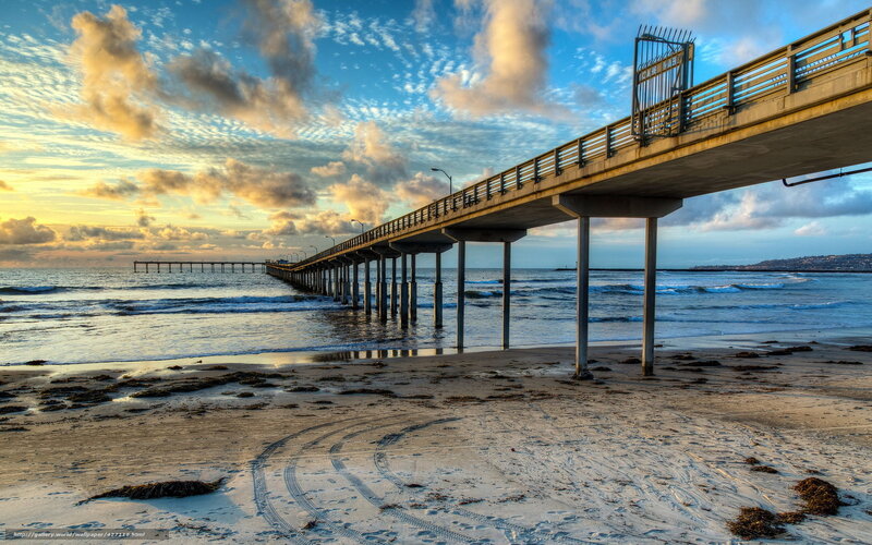 Pier at sunset with ocean waves