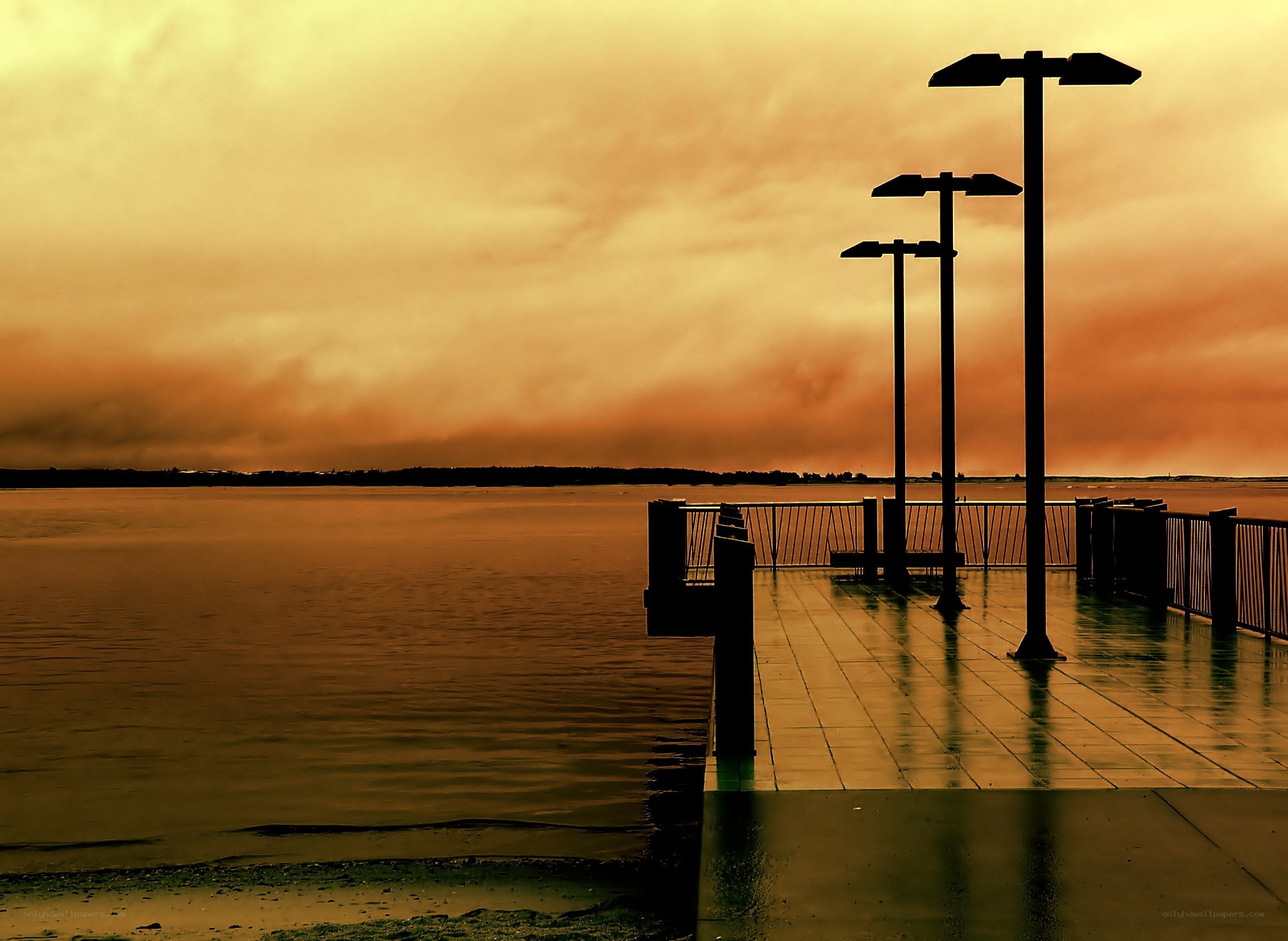 Pier at sunset with orange sky