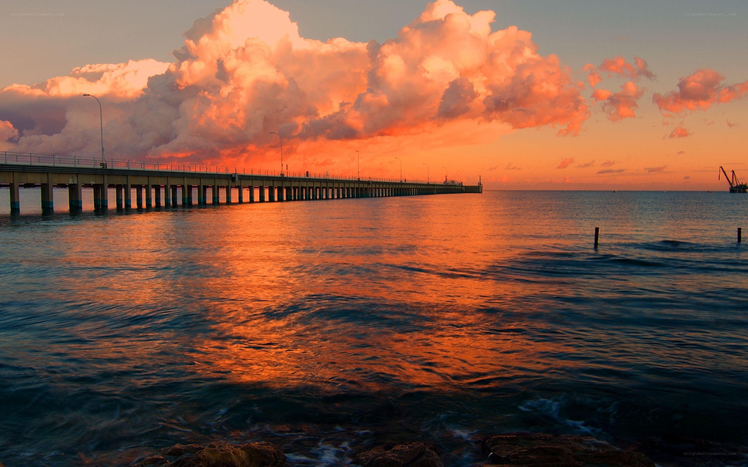 Pier at sunset with orange sky