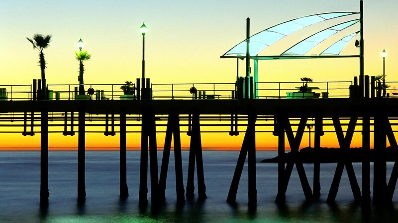 Pier at sunset with palm trees