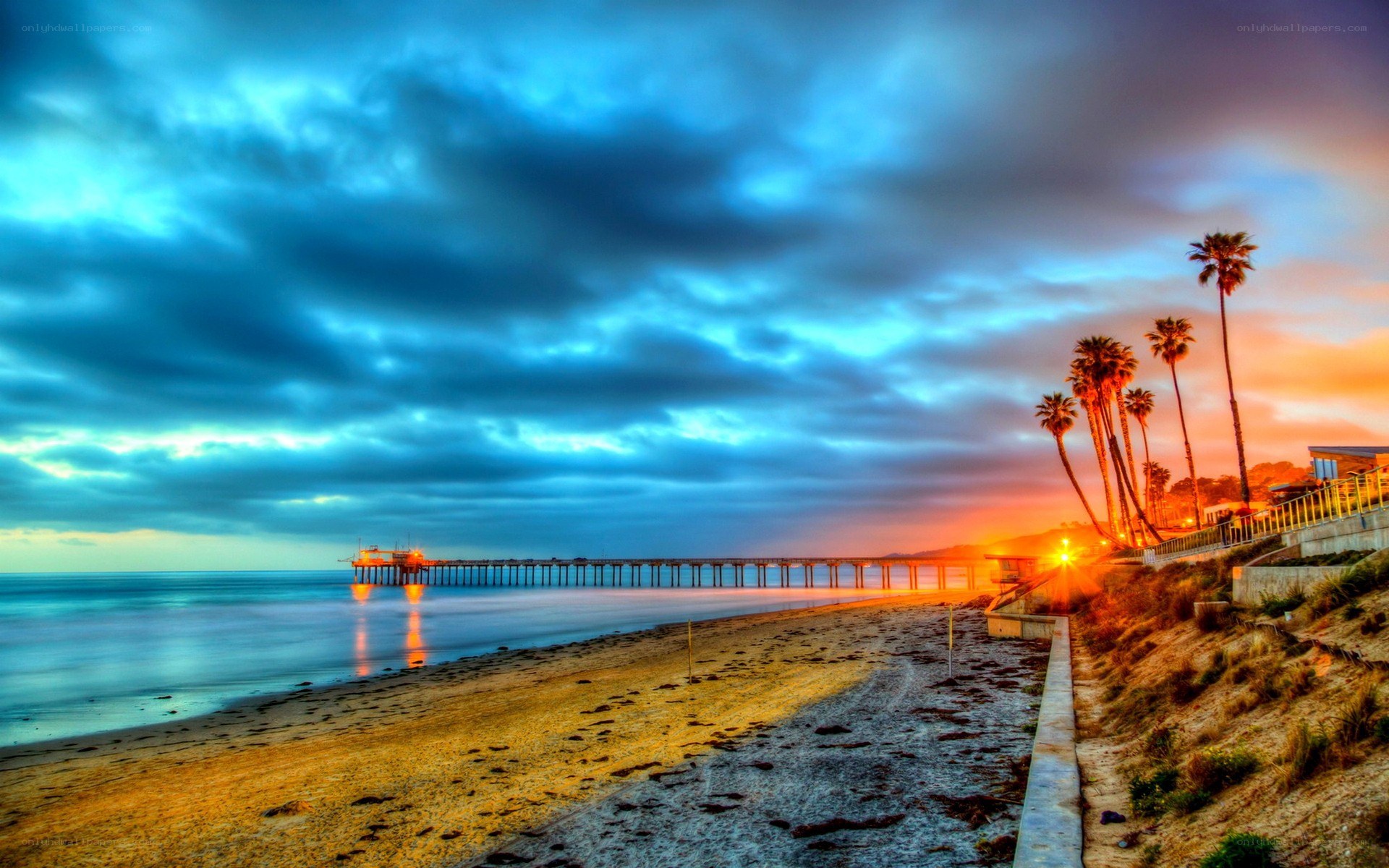 Pier at sunset with palm trees