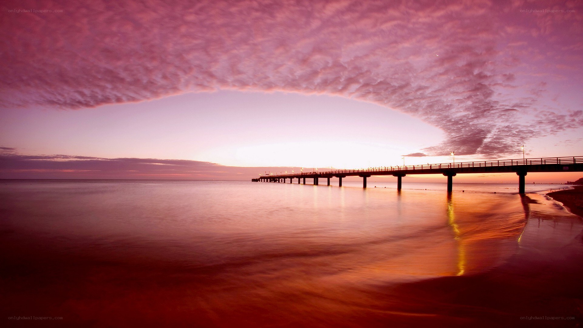 Pier at sunset with pink sky