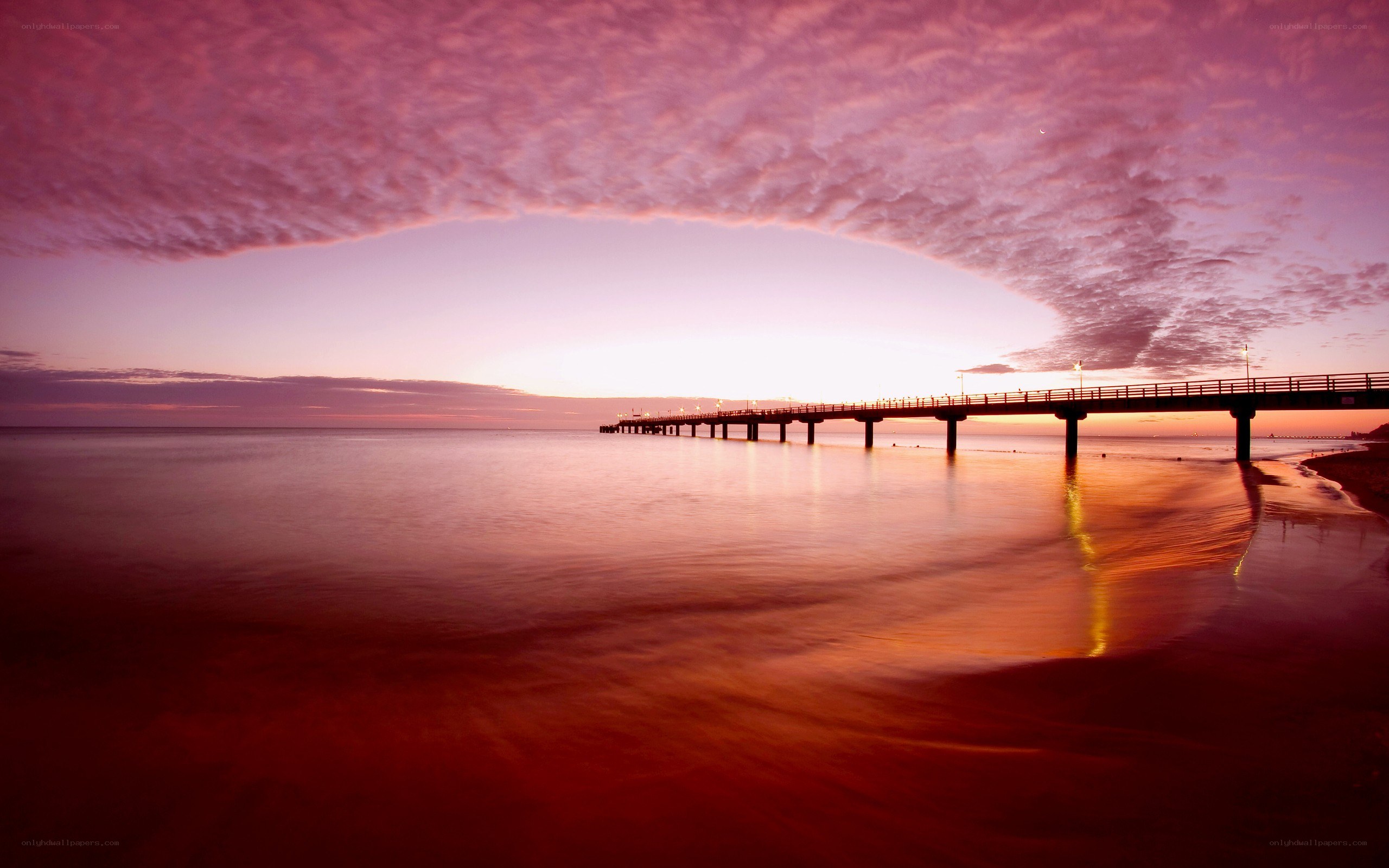 Pier at sunset with pink sky