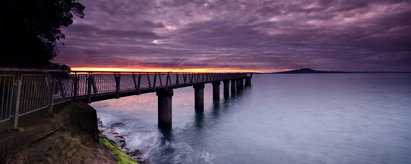 Pier at sunset with purple sky