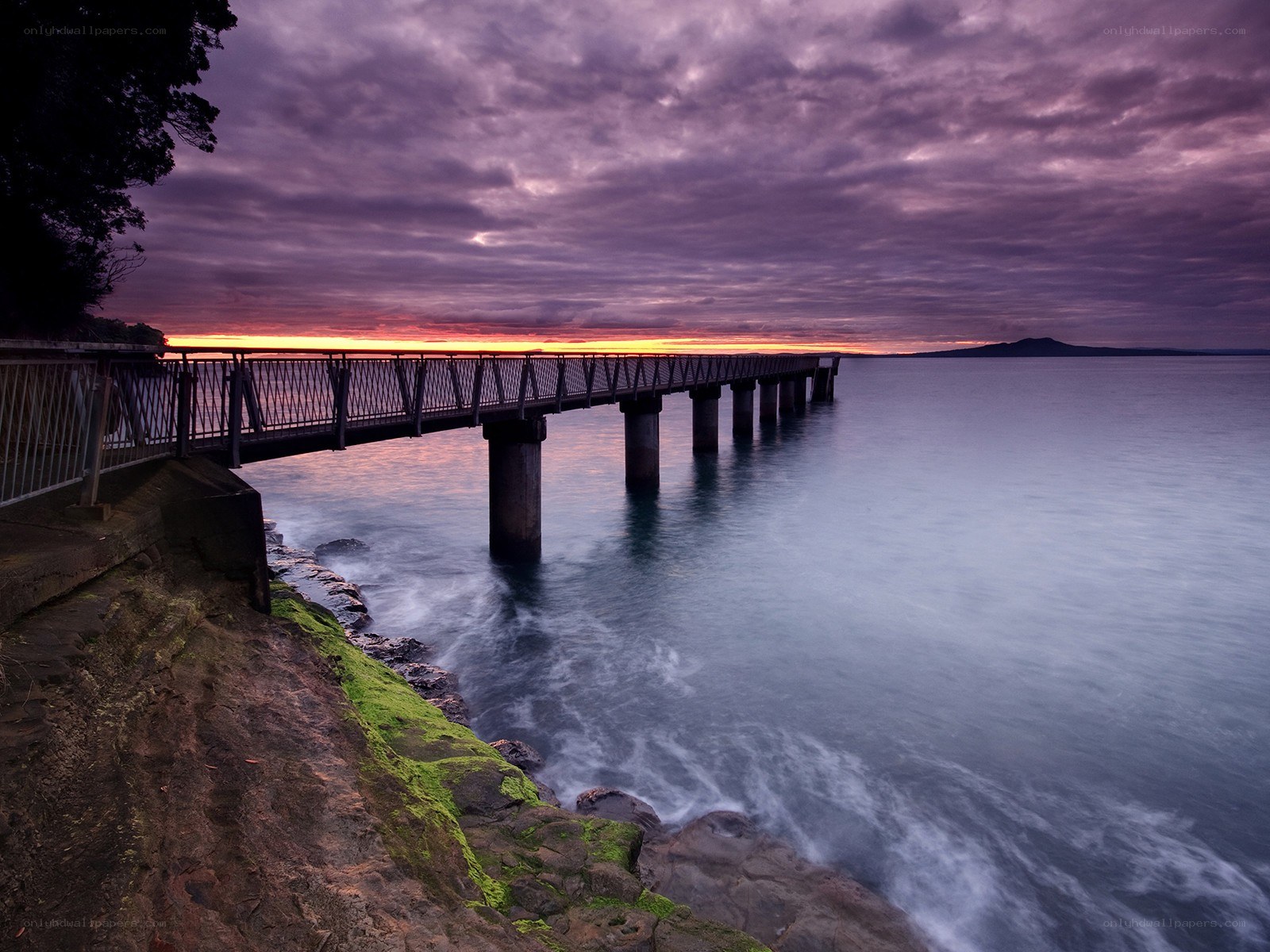 Pier at sunset with purple sky