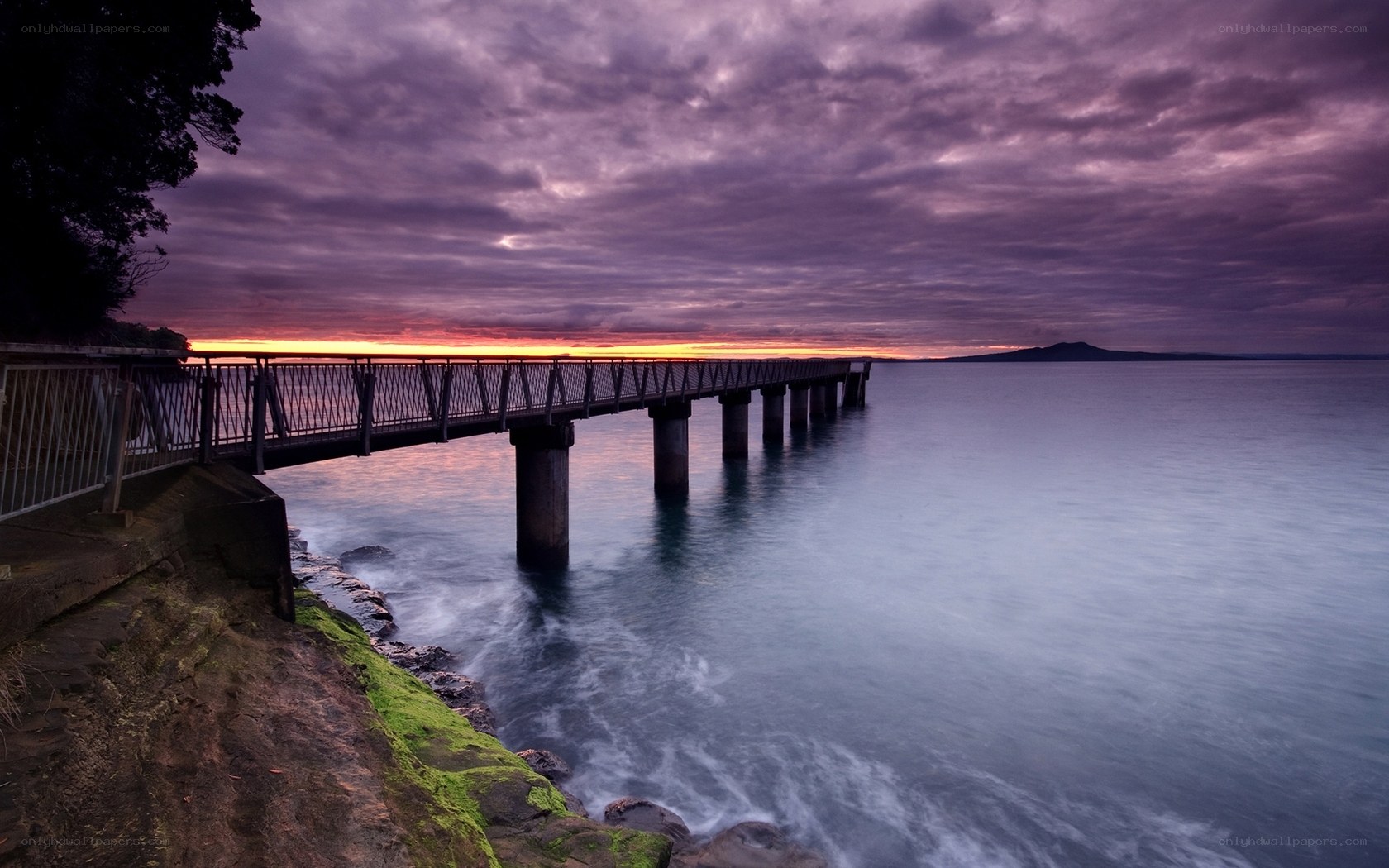 Pier at sunset with purple sky