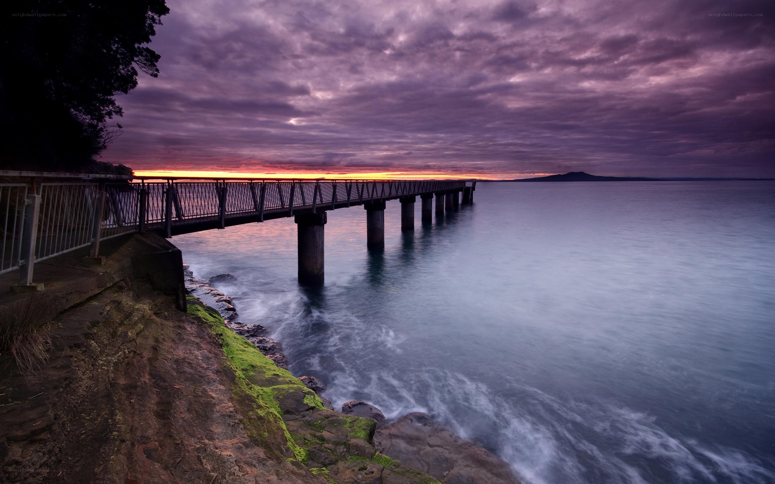 Pier at sunset with purple sky