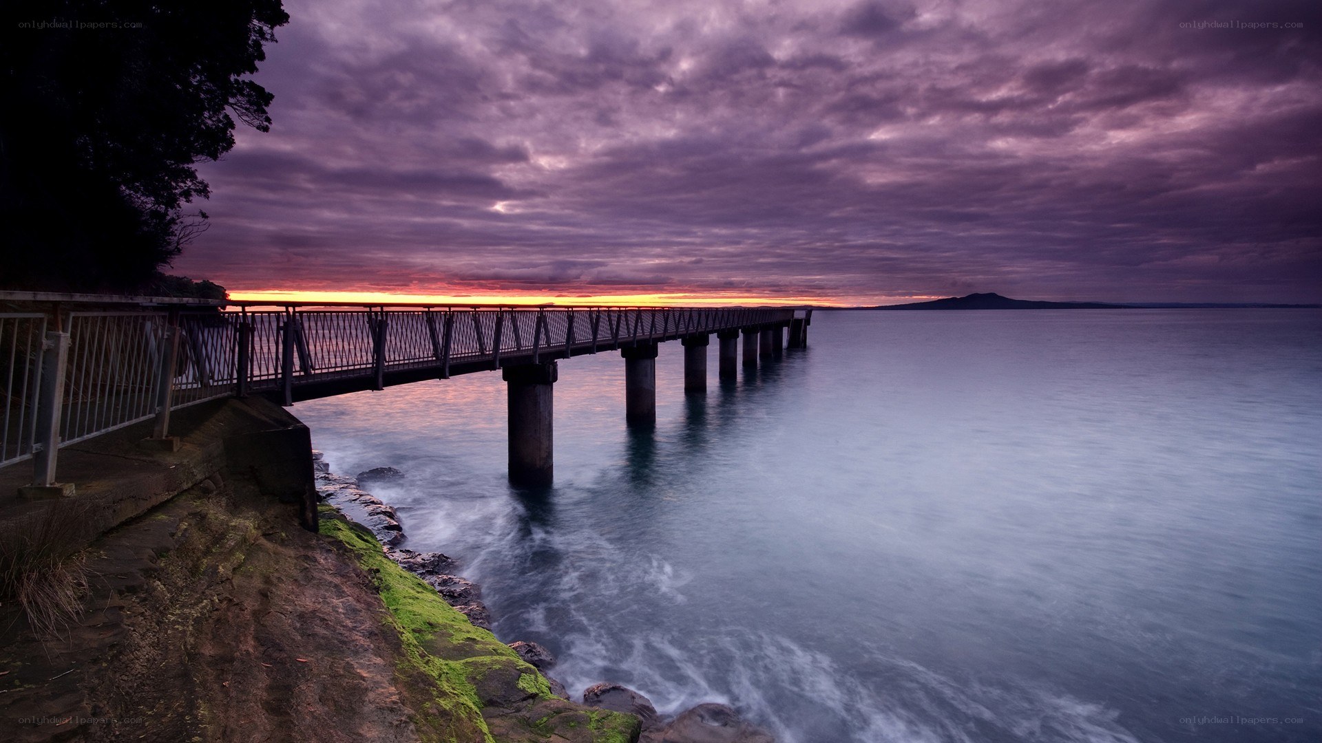 Pier at sunset with purple sky