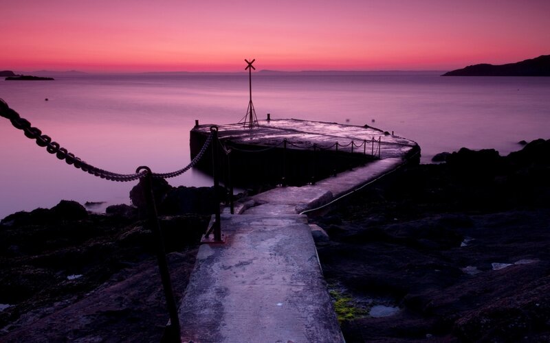 Pier at sunset with purple sky