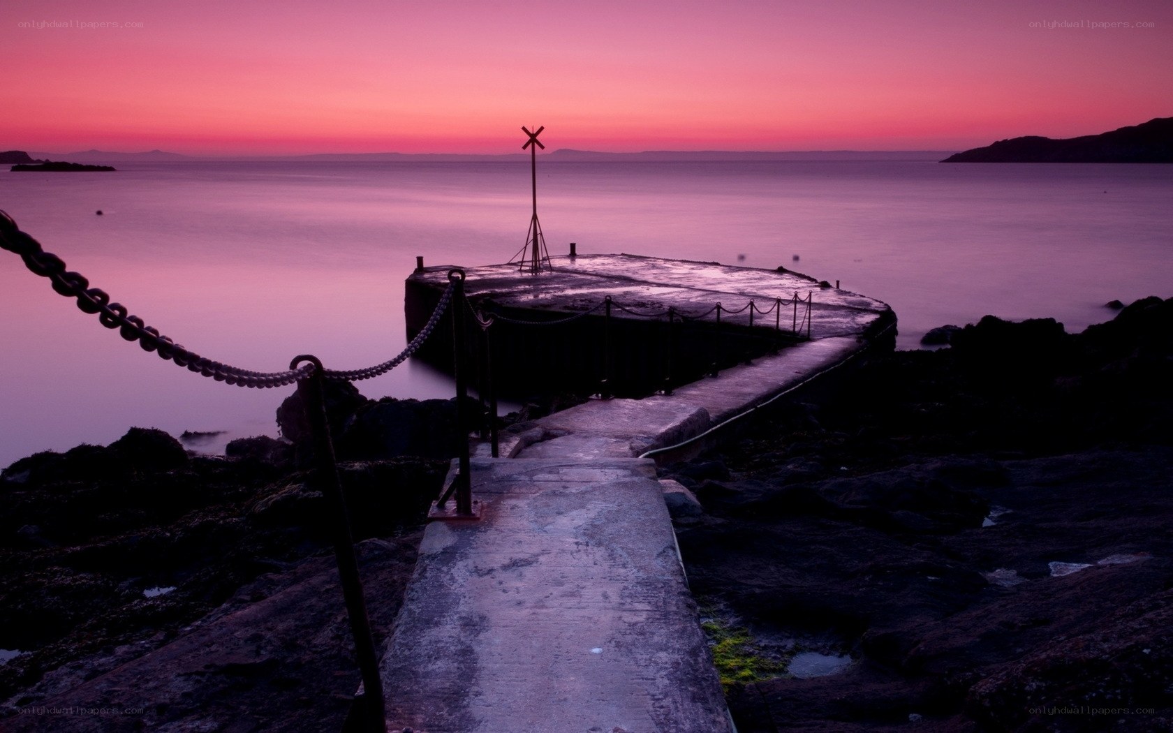 Pier at sunset with purple sky