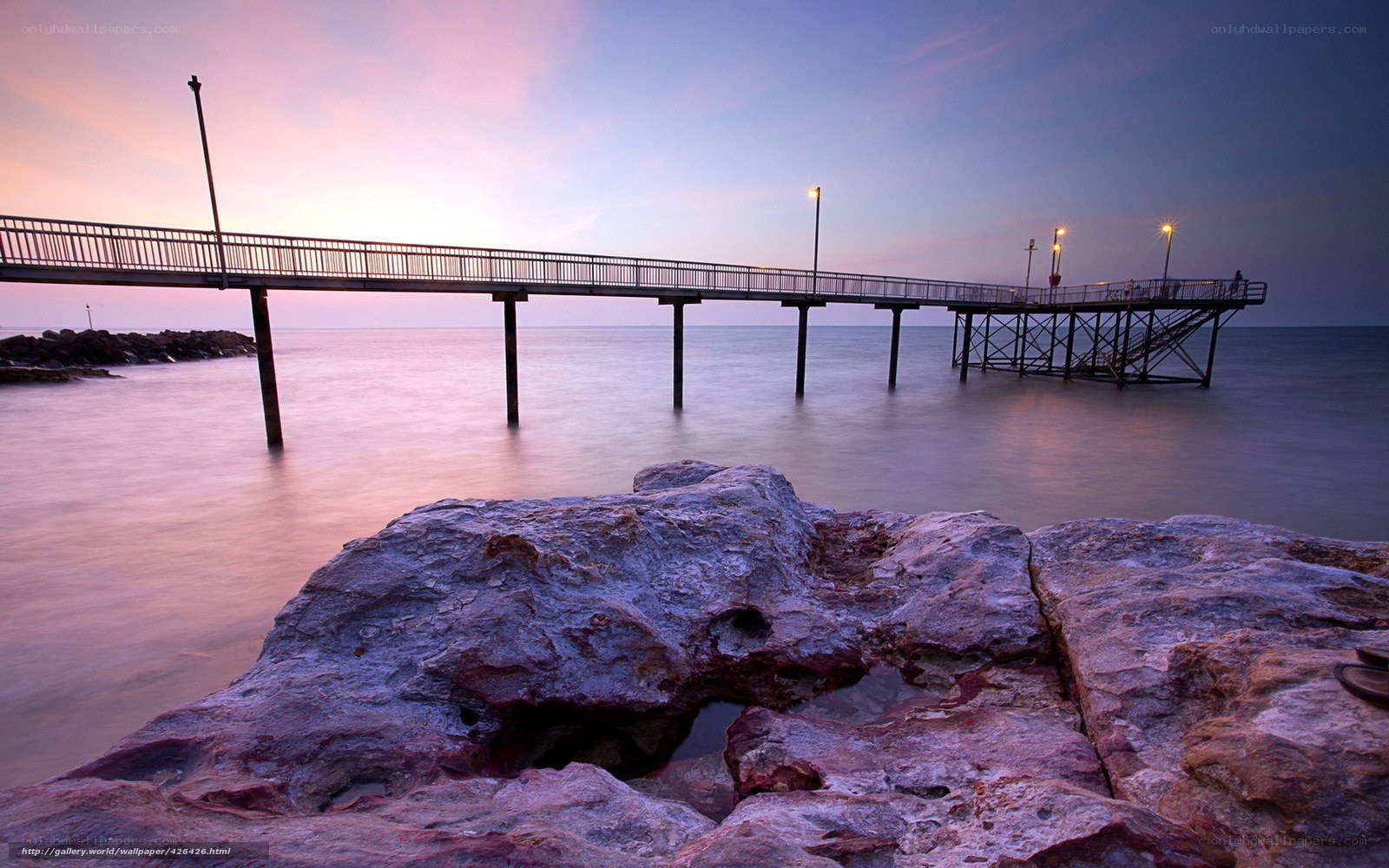 Pier at sunset with rocks