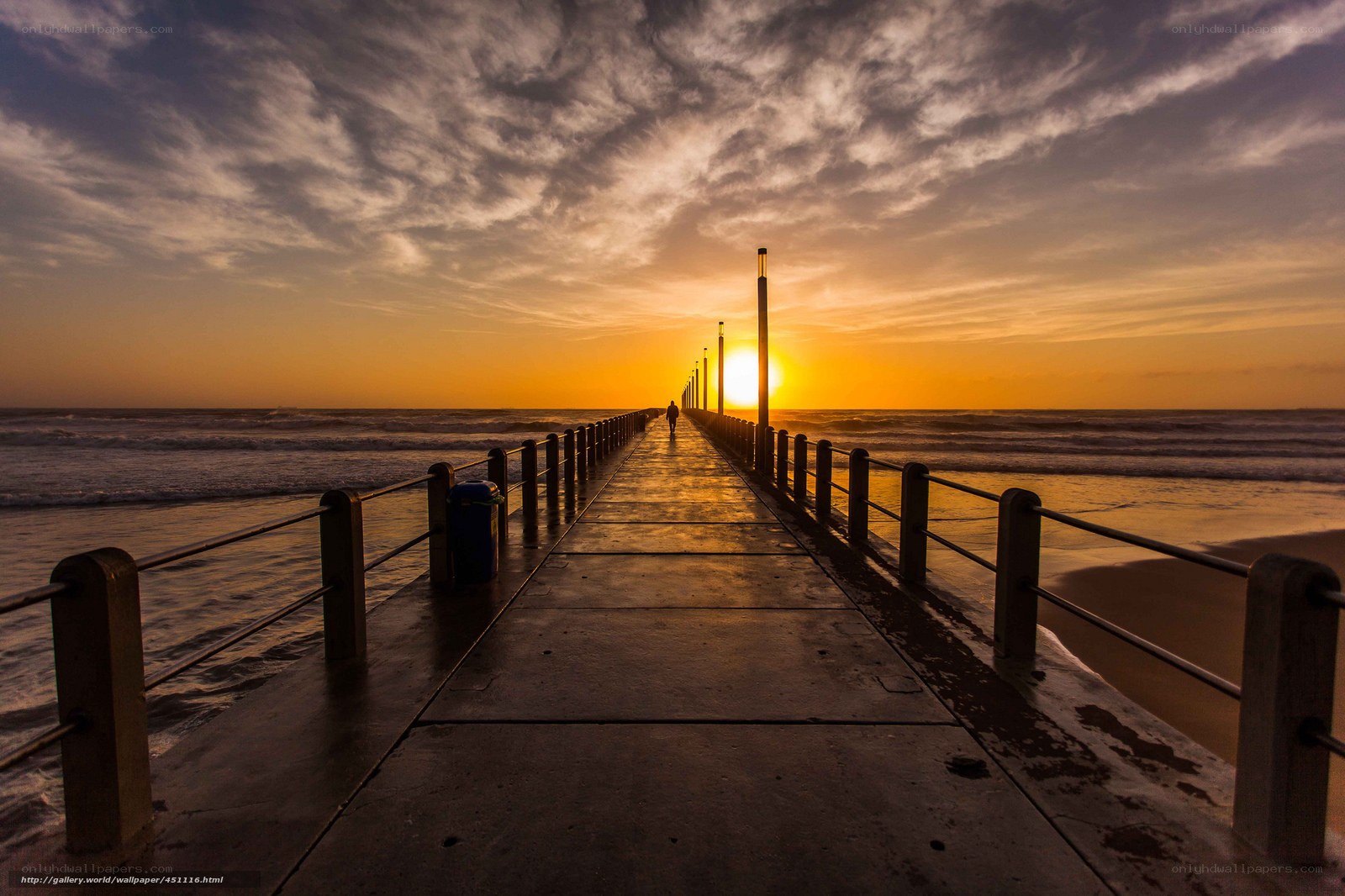 Pier at sunset with silhouetted figure