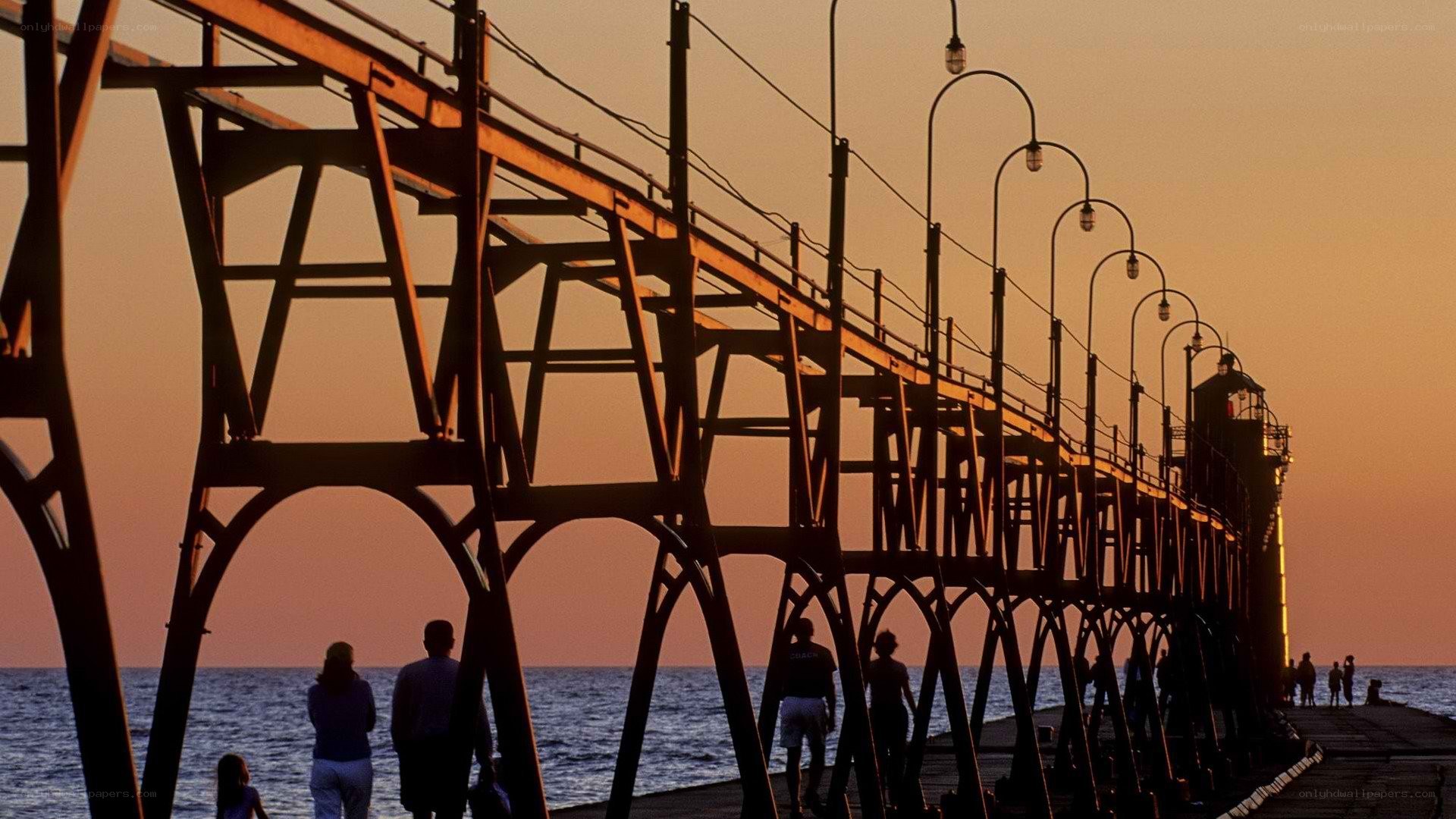 Pier at sunset with silhouettes