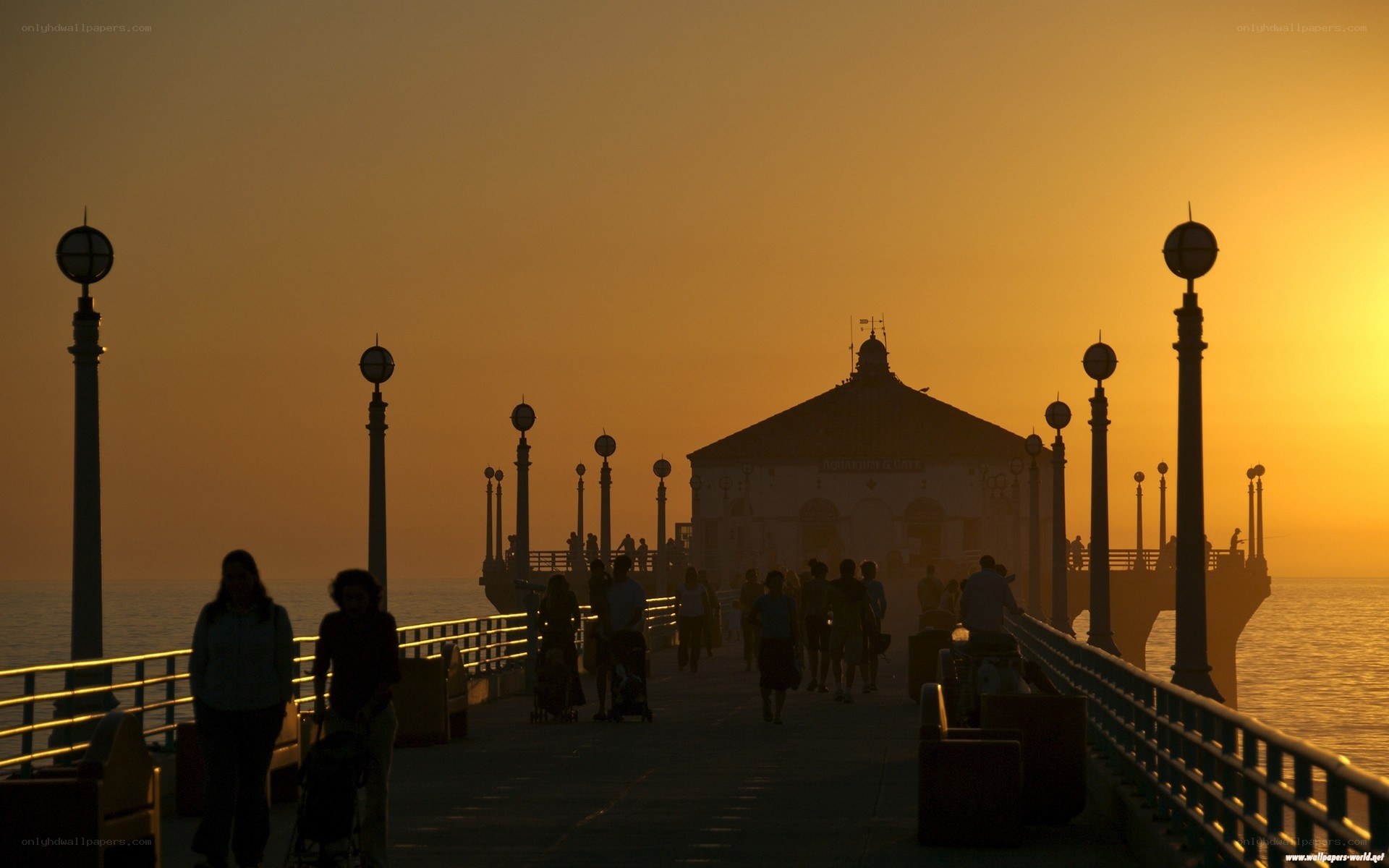 Pier at sunset with silhouettes