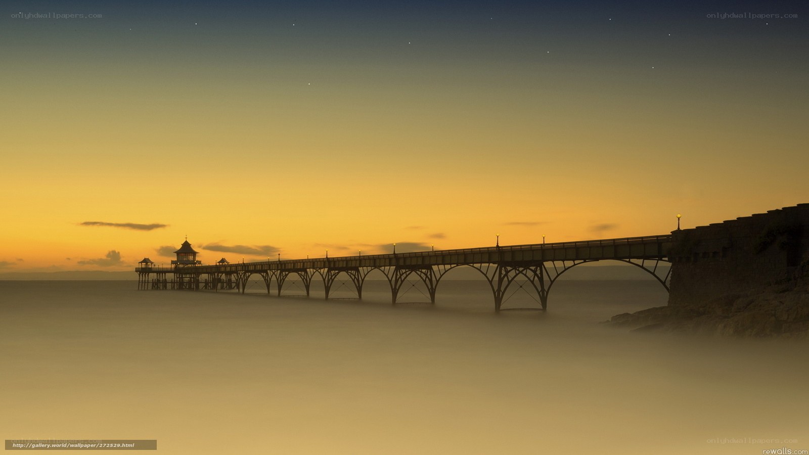 Pier at sunset with stars