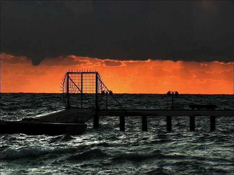 Pier at sunset with storm clouds