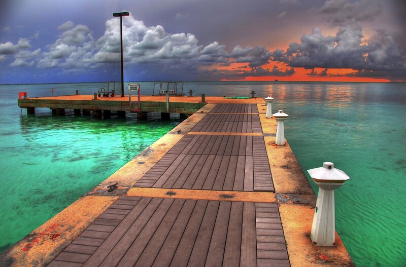 Pier at sunset with stormy sky