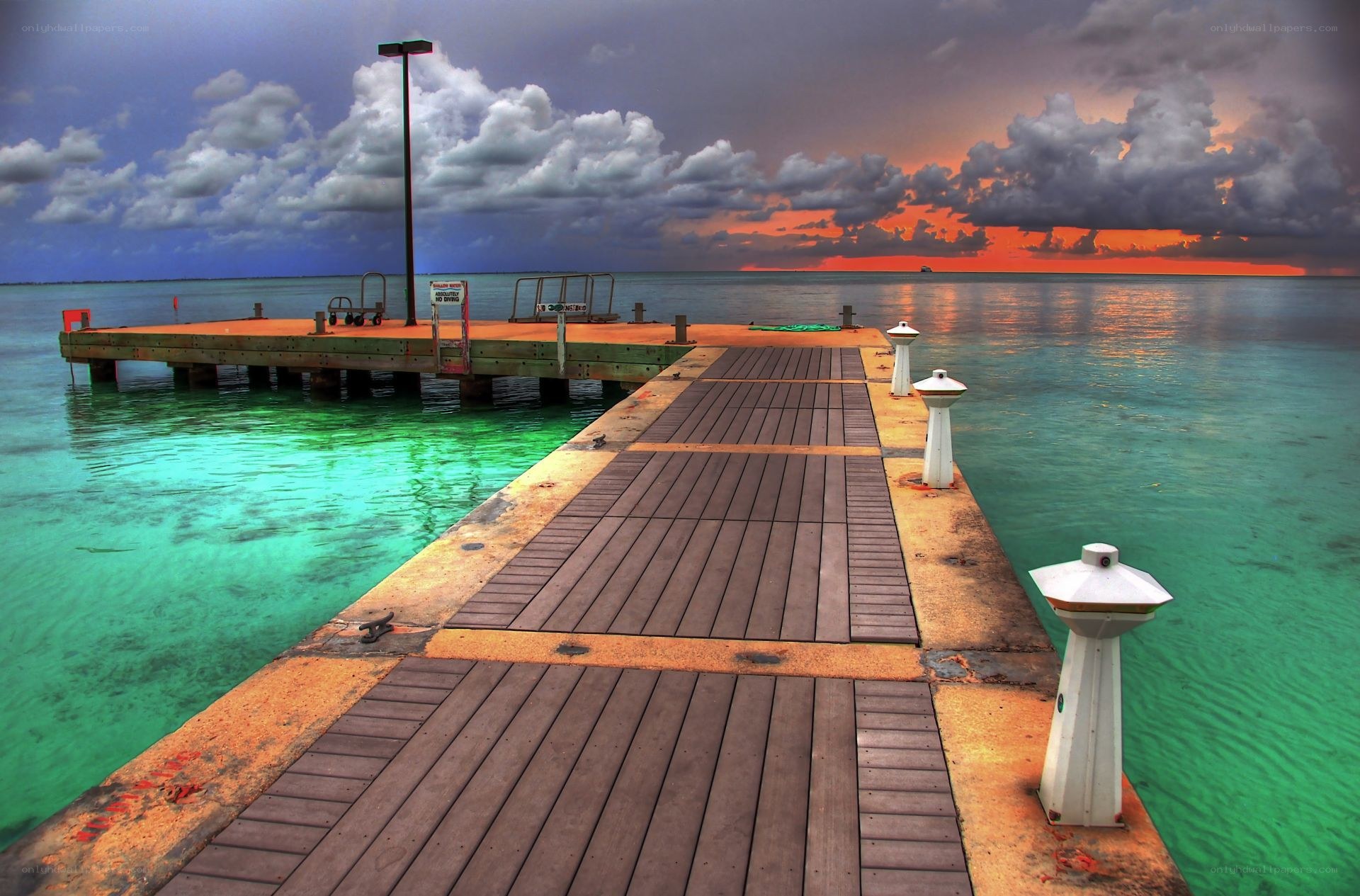 Pier at sunset with stormy sky