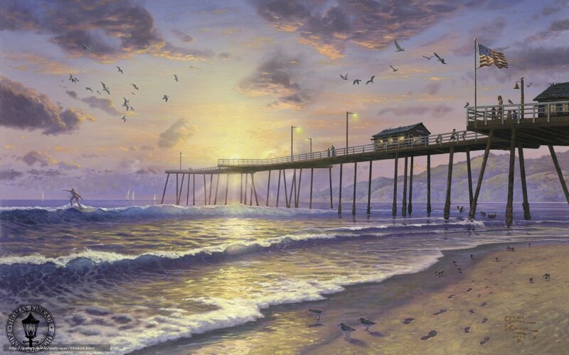 Pier at sunset with surfer